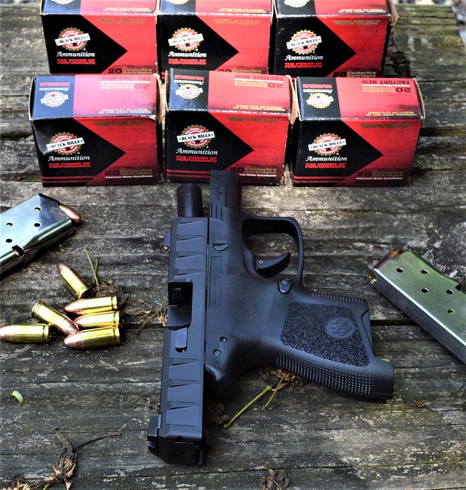 Beretta APX Carry with slide locked back and six boxes of ammunition