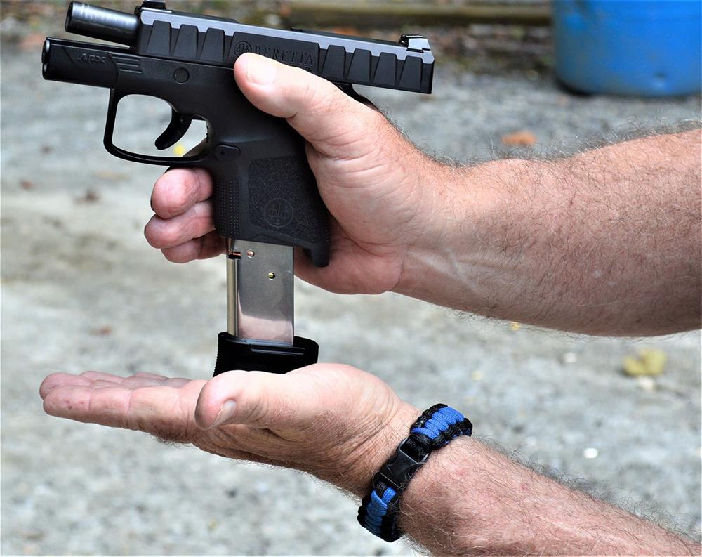 loading a magazine into a pistol