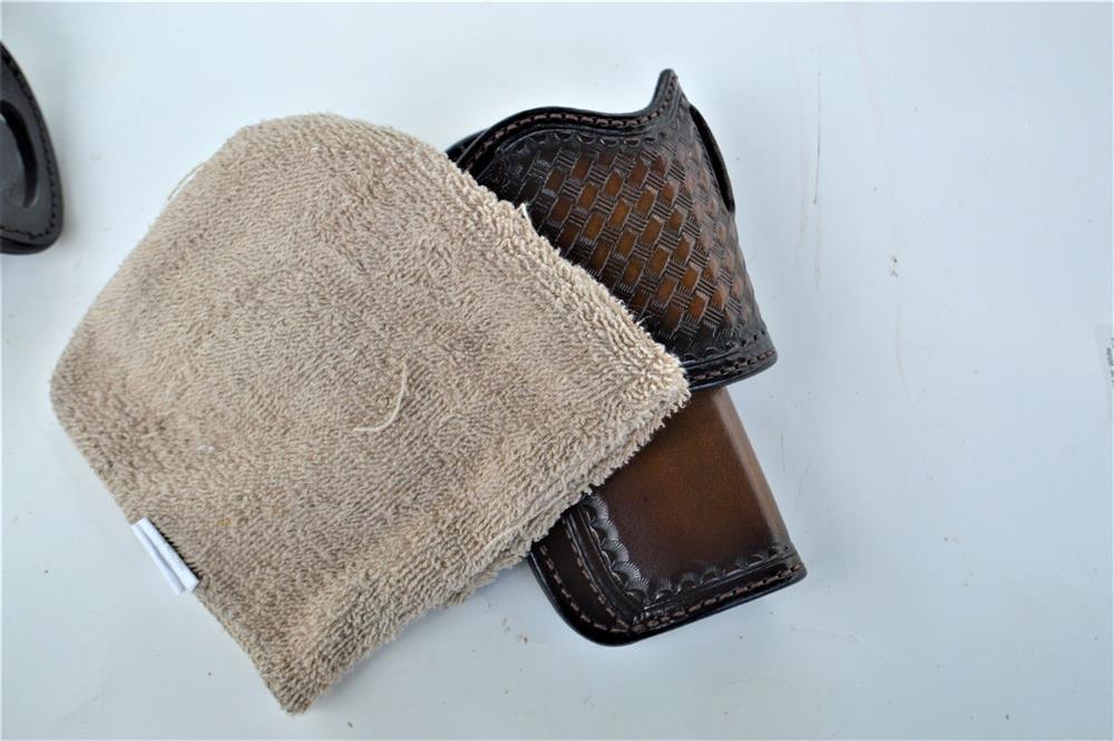 brown leather holster with cleaning cloth