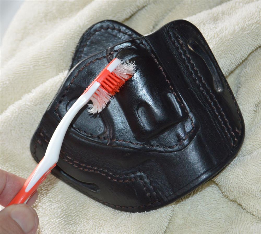 Cleaning a holster with a toothbrush