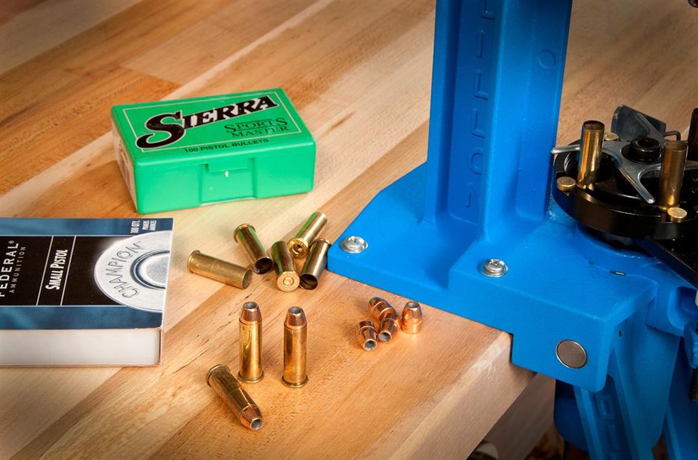 reloading press with a box of Sierra bullets ready for reloading