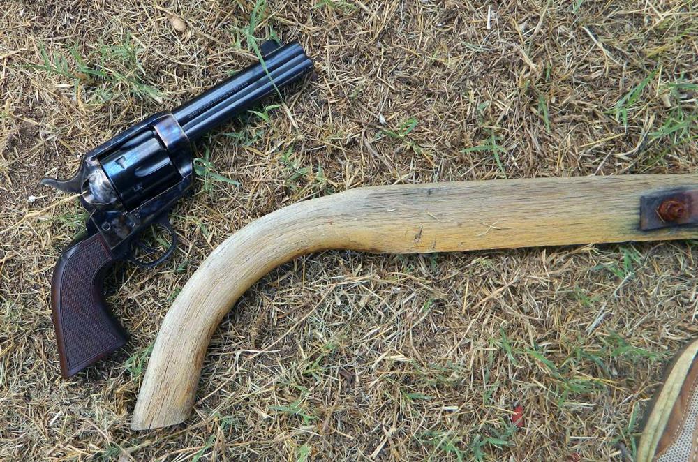 Traditions reproduction revolver measured against a plow handle to show grip similarity