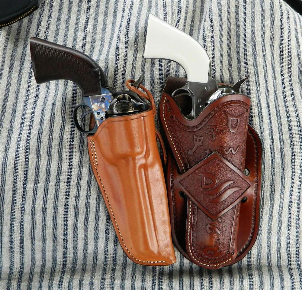 Two traditional leather holsters for cowboy action revolvers