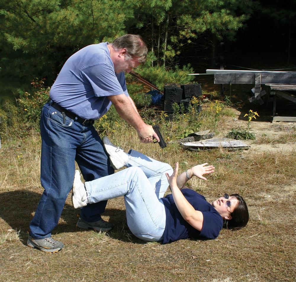 armed man standing over a defenseless woman on her back challenging the heroic consequences of action and inaction