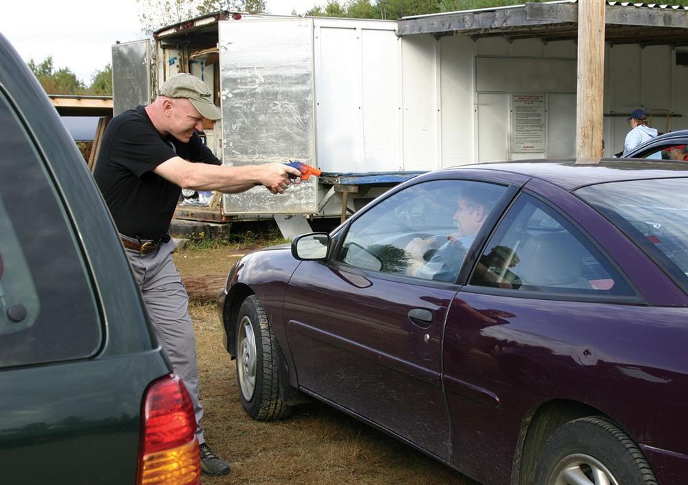 Carjacking scenario questioning whether the armed person is a bad guy or police officer challenging the heroic consequences of becoming involved