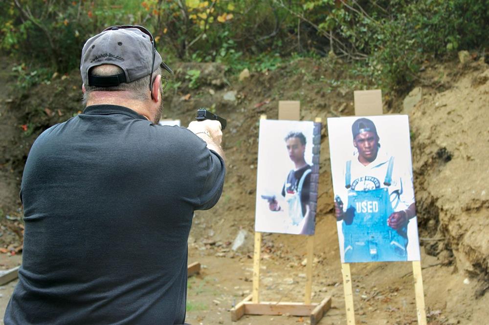 Man shooting at targets depicting armed bad guys