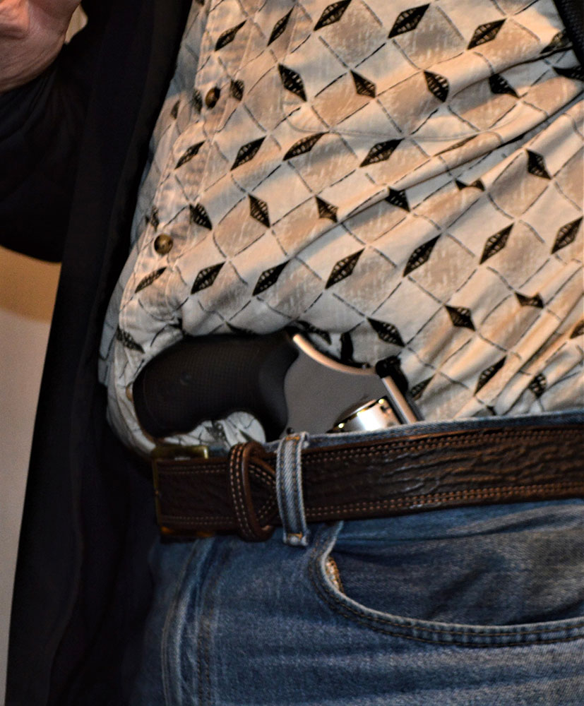 Man with revolver tucked into his waistband to demonstrate holsterless carry