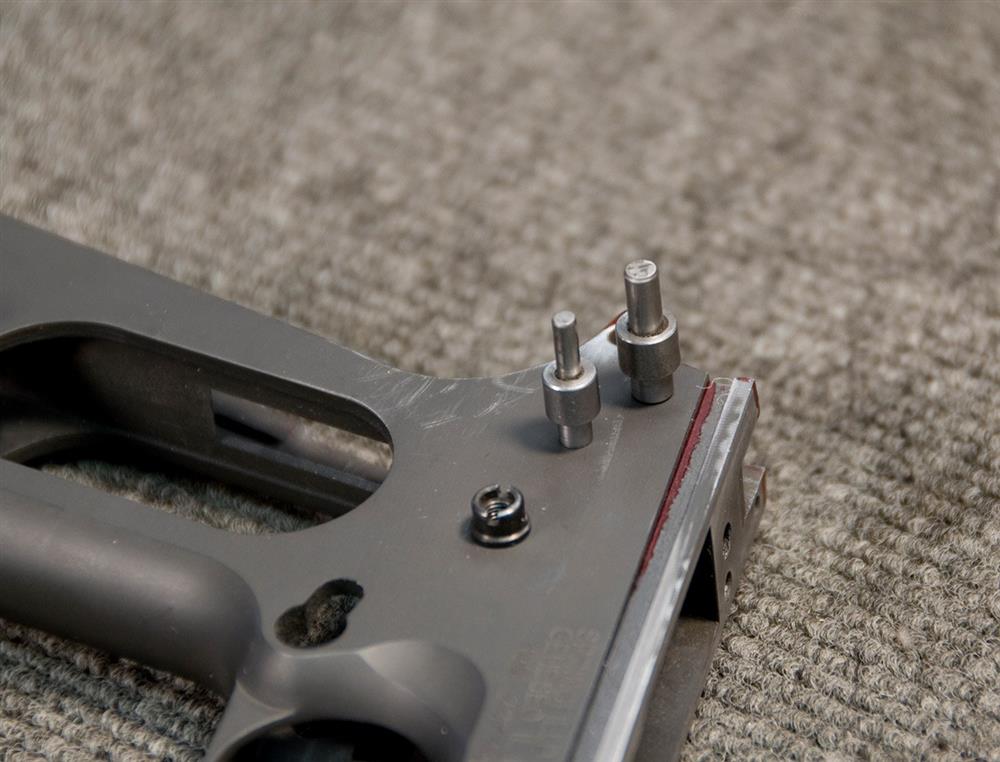 pins acting as a jig to insert the ear and hammer on a 1911 pistol