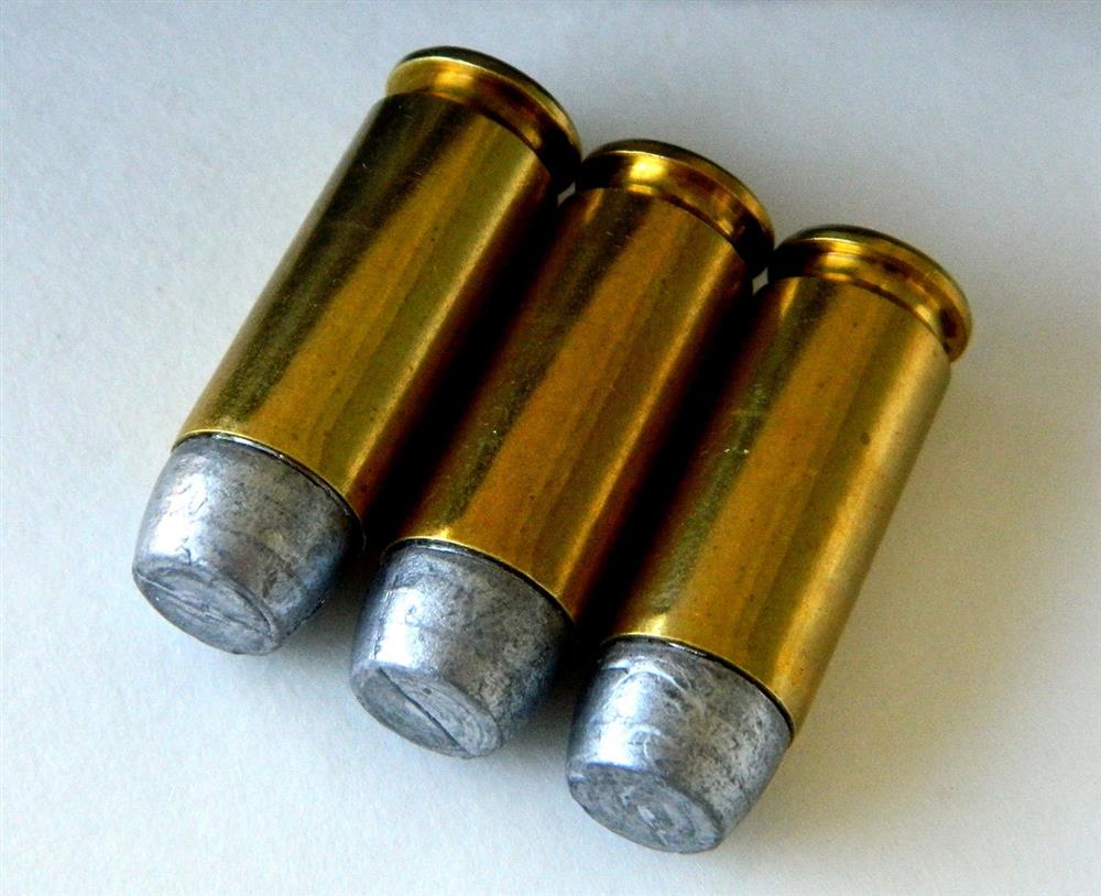 three brass cartridges loaded with Buffalo Bore hard cast lead bullets