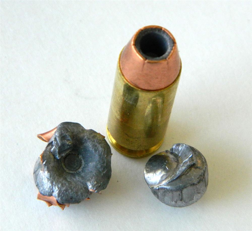 Double Tap 10mm cartridge showing a 135-grain JHP bullet over a 95-grain lead ball