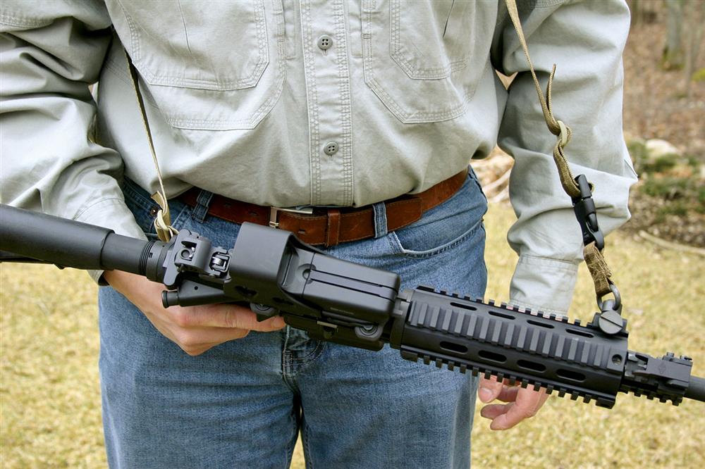 AR-15 rifle with alternatively mounted sling