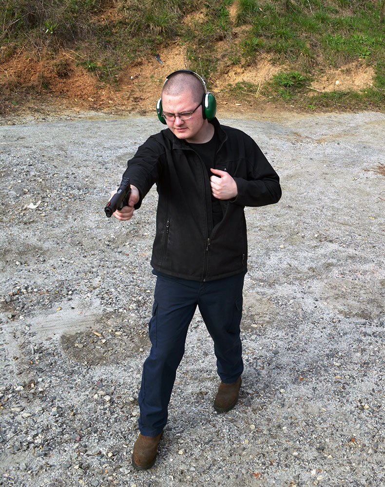 man moving while shooting a pistol for training