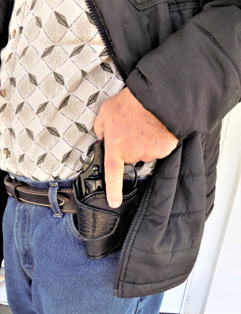 Man training for a perfect draw of a handgun from a concealed holster