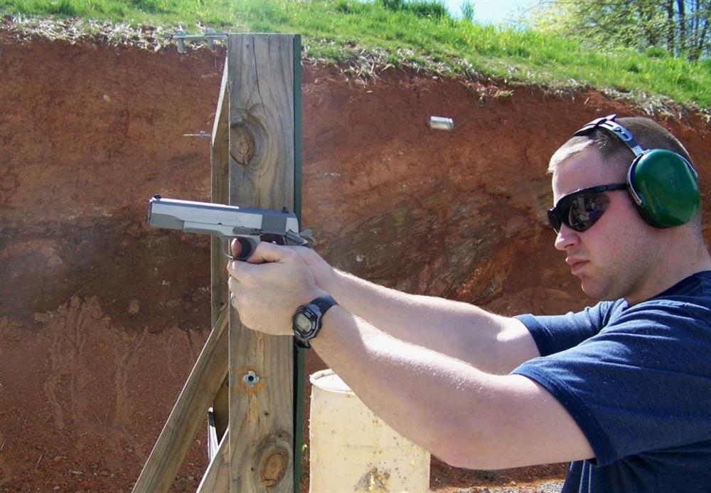 Man shooting a controlled pair showing a spent shell casing in the air