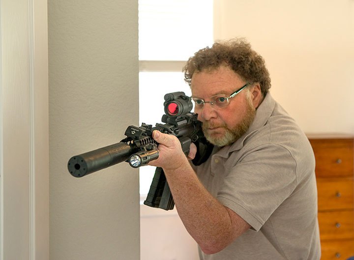 David Kenik aiming an AR-15 for home defense.